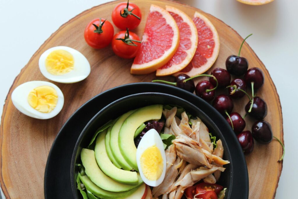 A range of healthy foods for your wellbeing such as avacados, chicken and eggs.