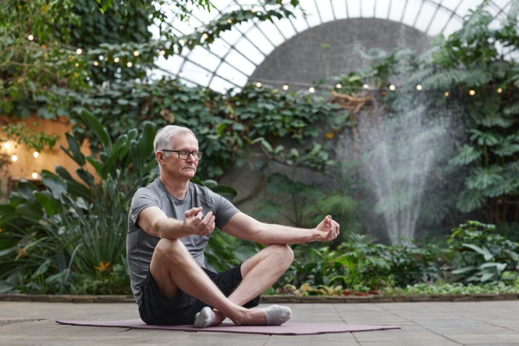 Older man in the meditative position to help him calm his anxiety