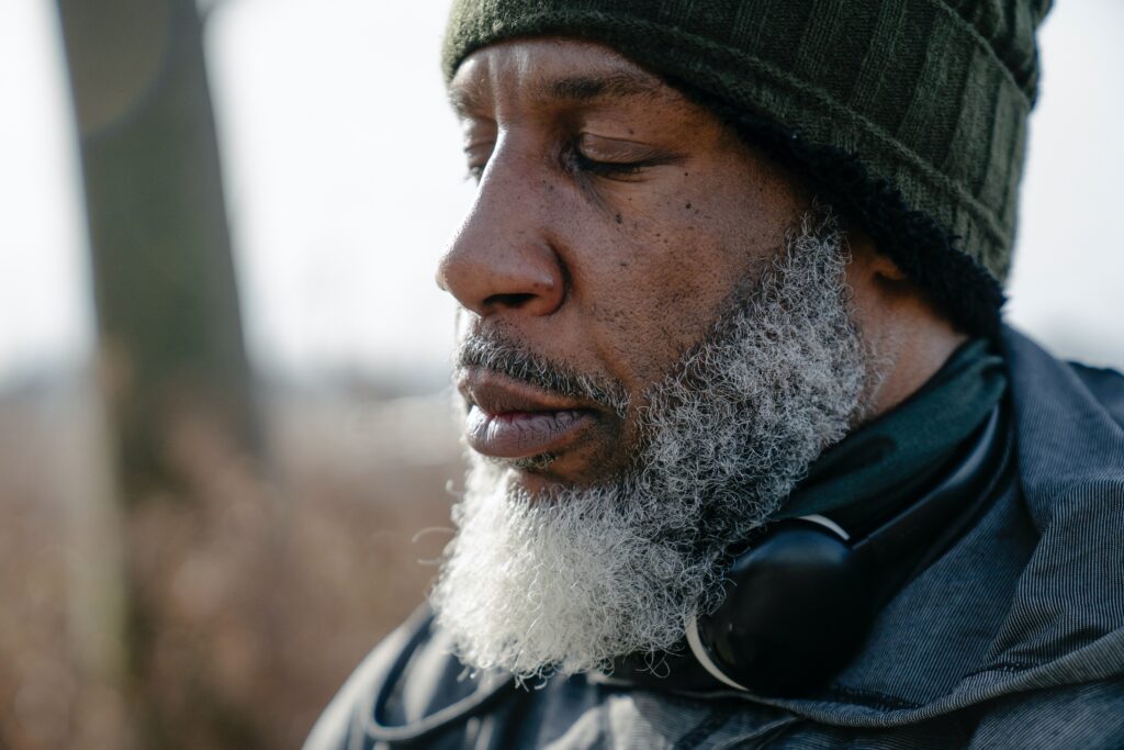 Man in the meditative position, practicing gratitude and taking care of his wellbeing