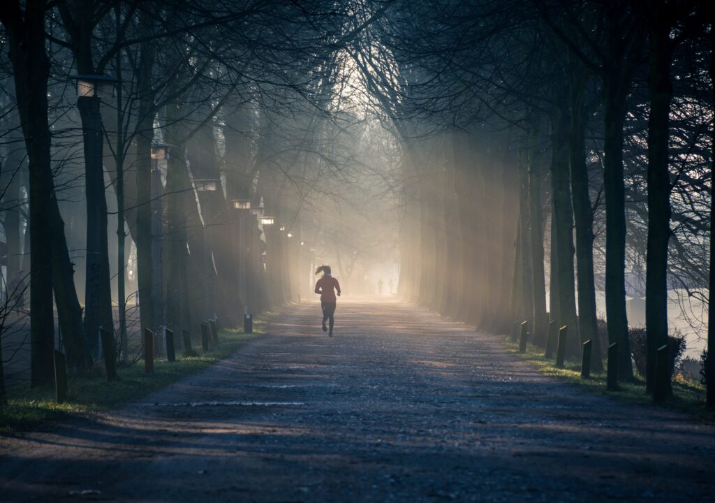 Woman running in nature for her wellbeing